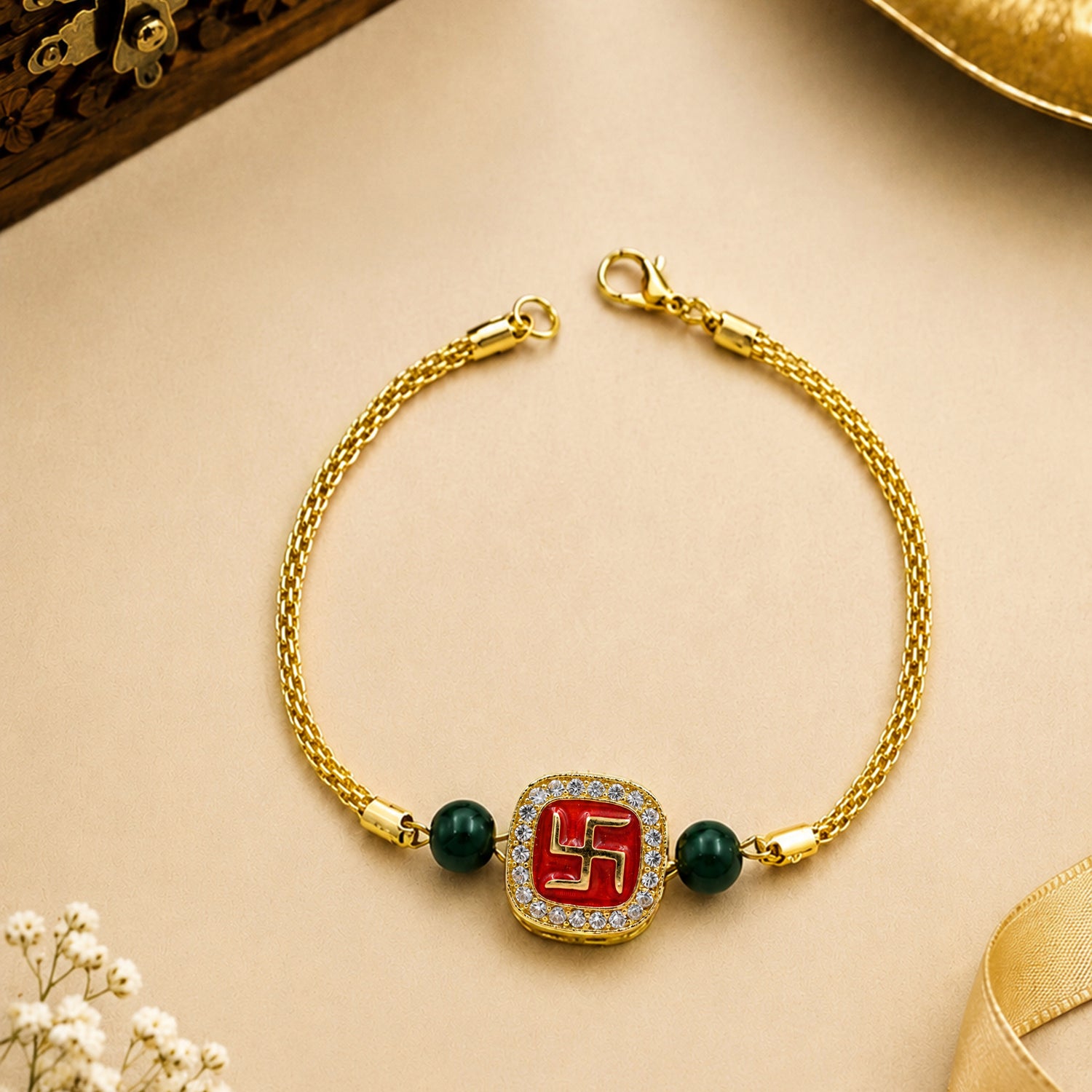 Artklim Gold-Tone Swastik Designer Rakhi with Green Beads