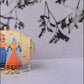 Indian Puppet Printed Oval Clutch